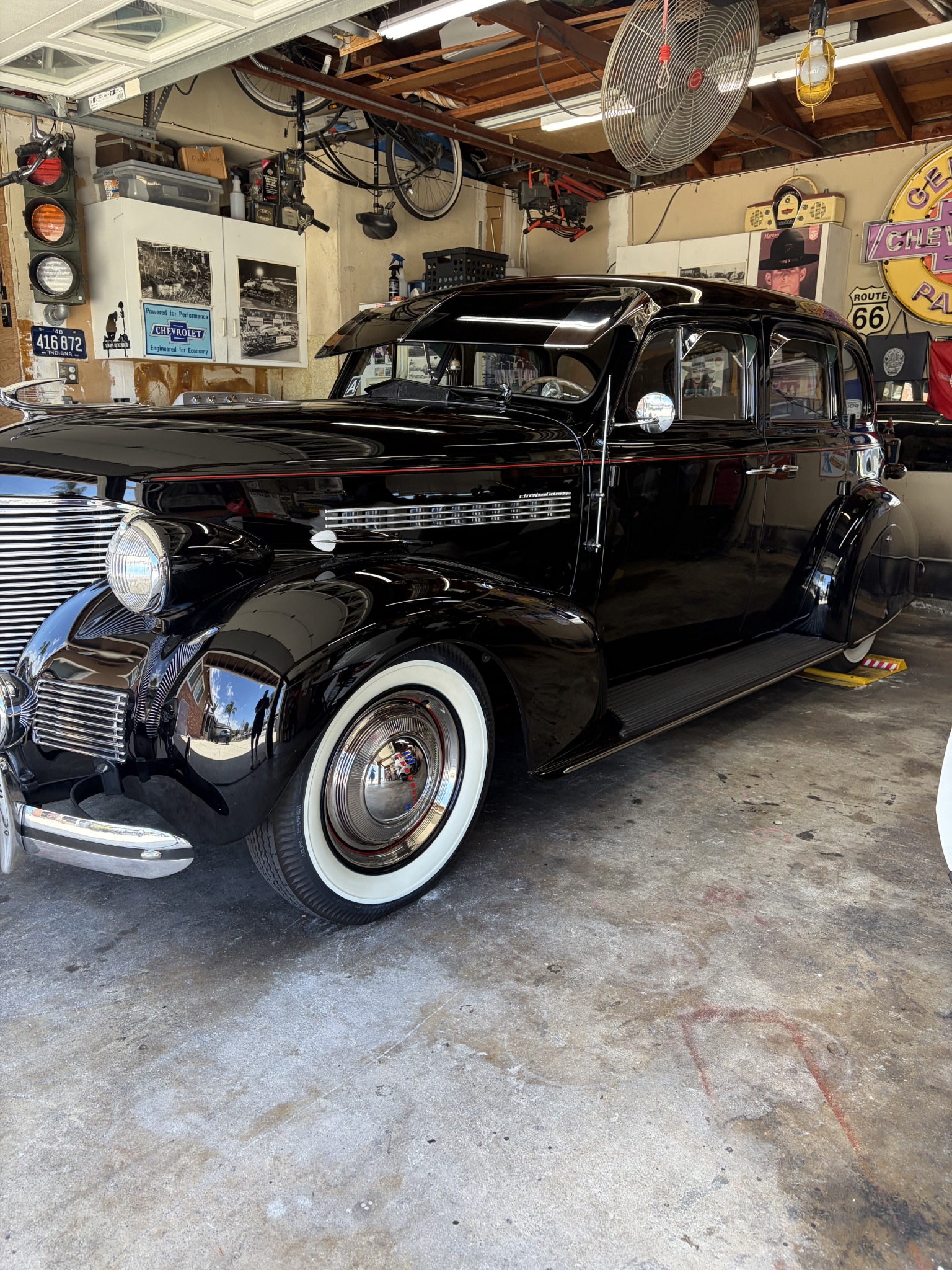 Black classic sedan in garage.